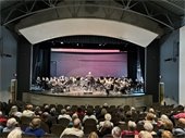 A group picture of an 80 piece concert band at the Chaska Community Center Theater.