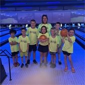 Adult and kids at a bowling alley