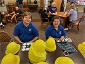 Cadets helping label hats.