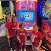 Girls smiling by a video game