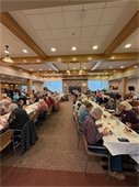 120 guests sit at the tables in The Lodge for Thanksgiving meal. 