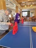 Two guys stacking cups at the tailgating party.