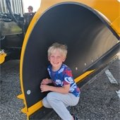 A boy smiling by a truck