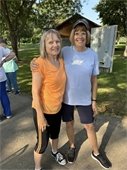 2 smiling ladies walking at Lions Park.