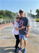 Smiling couple in front of the the water feature at Firemens Park during a Walk in the Park.