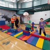 Kids playing in the gym with an instructor