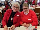 Photo of Two ladies wearing red enjoying a Lodge Valentine Party. 