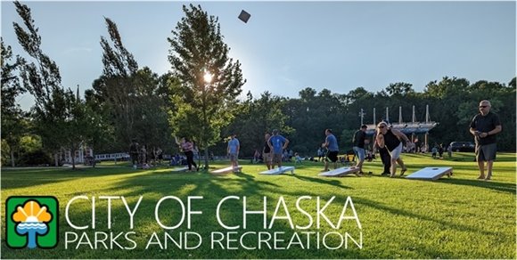 People playing bean bags in a park with Chaska Parks and Recreation