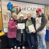 Picture of a winning team of people from a puzzle competition