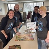 Picture of winning team of people at a puzzle competition