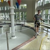 Picture of person cleaning a swimming pool
