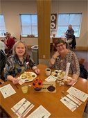 Two ladies enjoy the Lodge Thanksgiving Dinner.