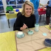 Woman smiling doing pottery