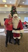 Santa and Lodge Member in front of the tree.