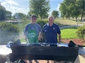 Two Chaska Lions Club Members grilling for a Senior Picnic.