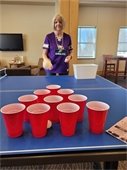 A vikings fan plays pong at the Lodge Tailgating Party!