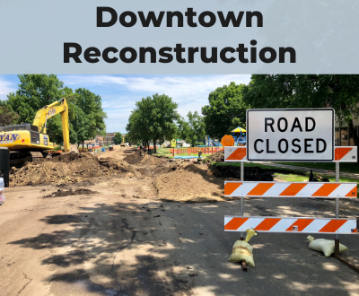 Downtown Reconstruction, road closed sign with construction equipment